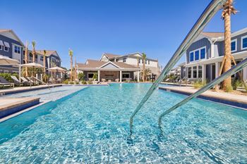 Resort style swimming pool with palm trees